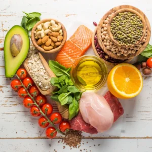 A heart shaped plate of food including meat, vegetables and nuts.